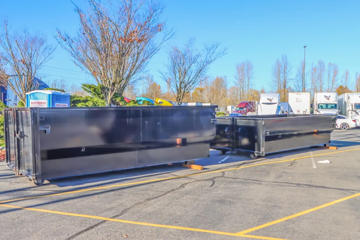 Professional dumpster rental service with roll-off container on residential driveway in Chocolay